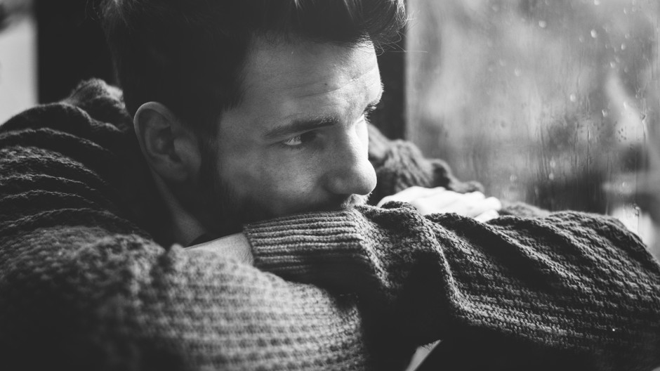 man-looking-out-window