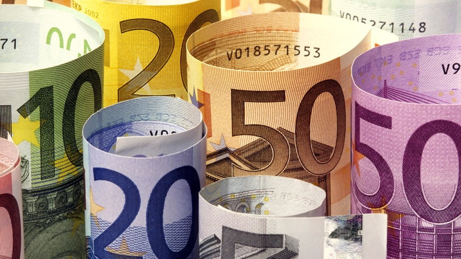 Peniaze euro bankovky zrolované do ruličiek