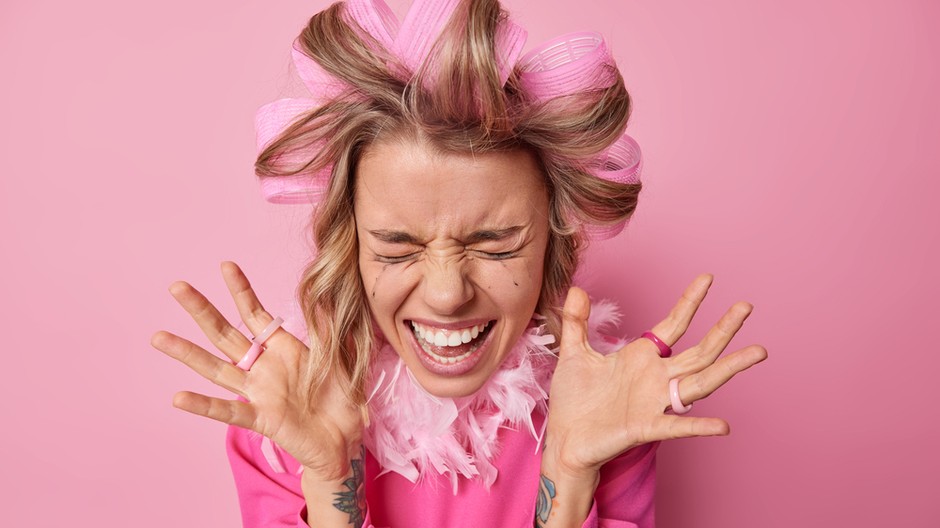 happy-emotional-young-woman-keeps-palms-raised-shouts-loudly